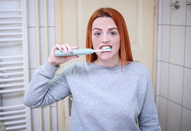 dívka si čistí zuby elektrickým kartáčkem